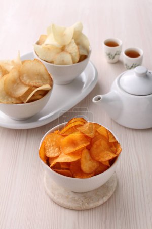 Photo for Potato chips on a plate and tea - Royalty Free Image