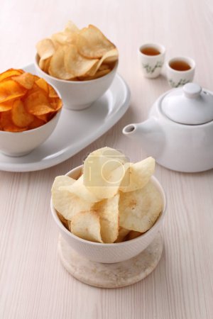 Photo for Potato chips and tea - Royalty Free Image