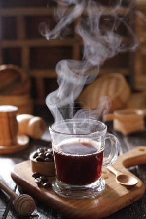 Photo for Black coffee hot drink on old wooden table - Royalty Free Image