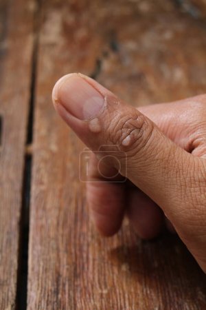Photo for Finger on a wooden background, macro shot - Royalty Free Image