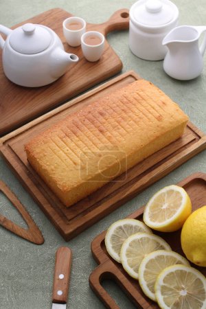 Photo for A vertical shot of a delicious lemon slices and sugar on a wooden tray - Royalty Free Image
