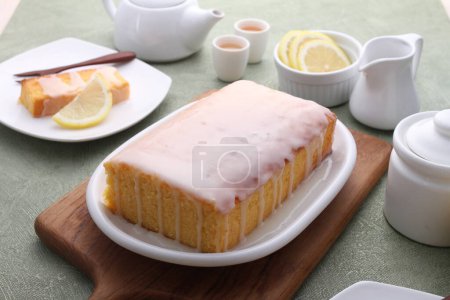Photo for A piece of cake and a lemon slice on the table - Royalty Free Image