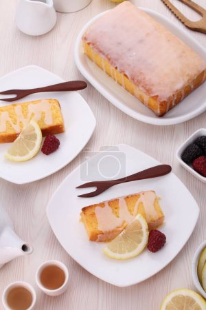 Photo for Delicious fresh baked cake with honey and lemon on white plate - Royalty Free Image