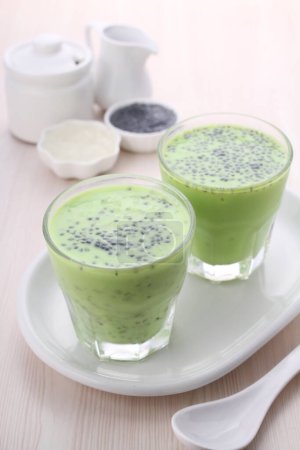 Téléchargez les photos : Un verre de thé vert avec du lait et une tasse de thé - en image libre de droit