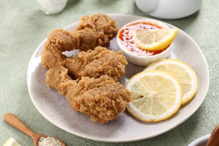 Photo for Plate with fried chicken and lemon on table - Royalty Free Image
