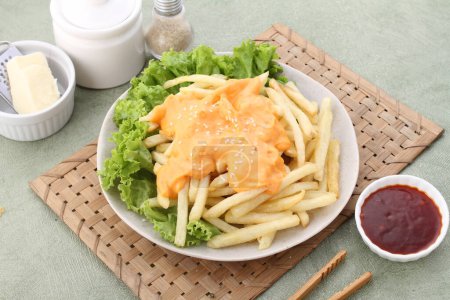 Photo for French fries with cheese and salad on plate. - Royalty Free Image