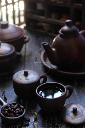 Photo for Coffee cup with teapot and tea on a wooden table - Royalty Free Image