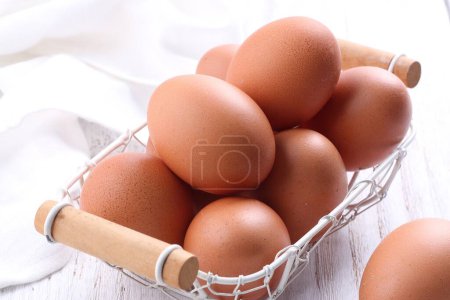 Photo for Raw chicken eggs in wooden box, top view. - Royalty Free Image