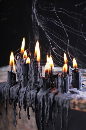 Photo for Burning wax candles on black table - Royalty Free Image