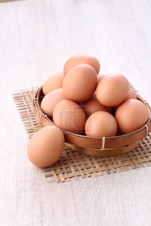 Photo for Eggs in a wooden basket - Royalty Free Image