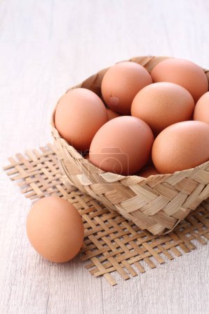 Photo for Brown eggs in a wooden bowl - Royalty Free Image