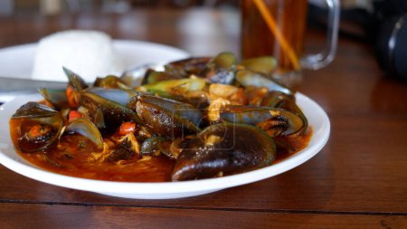 Foto de Green scallops cooked in Padang sauce. Indonesia food. - Imagen libre de derechos