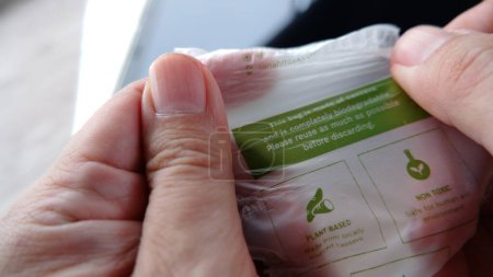 Téléchargez les photos : Plastic strength test made of plant based cassava. Biodegradable plastic bag. Jakarta, 20 january 2022. - en image libre de droit