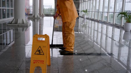 Photo for Yellow caution wet floor sign at MRT station - Image of danger, cleaning in progress at public space. Jakarta, 9 April 2022. - Royalty Free Image