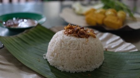 Photo for Uduk rice with quail egg satay and fried tofu. Indonesia food. - Royalty Free Image