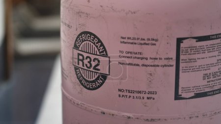 Photo for Refrigerant or freon gas cylinder r32 to fill freon gas in AC. Jakarta, 18 July 2023 - Royalty Free Image