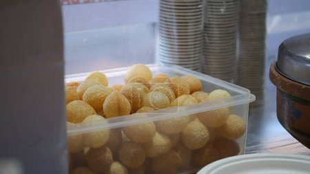 Golgappa or Pani Puri is a deep-fried breaded hollow spherical shell, about an inch (2.5 cm) in diameter, on a plastic basket.