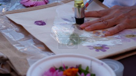 Eco print on fabric with fresh flowers.
