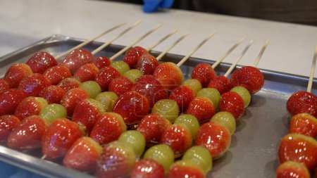 Skewered Fruits coated in sugar rock or Bintang Hulu. Chinese sweet snack.