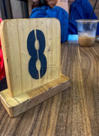 Photo for Table numbers made of wood lie on the restaurant table - Royalty Free Image