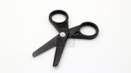 Photo for Black scissors with a small size on a white background. - Royalty Free Image
