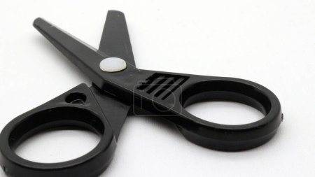 Photo for Black scissors with a small size on a white background. - Royalty Free Image