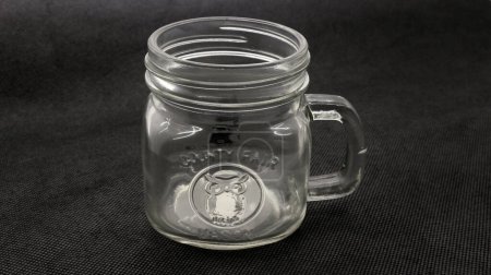 Photo for Clear glass cup with handle and glass cover, looks cute and antique, with a contrasting background adding sharpness to the object. - Royalty Free Image