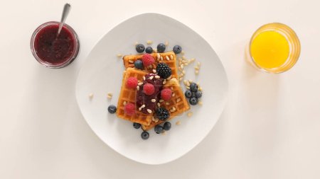 Photo for Belgian waffles, delicious dessert. Fresh baked goods with berries. - Royalty Free Image