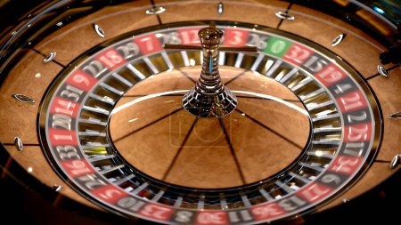 Photo for Roulette table in a casino with many games and slots, roulette wheel in the foreground. Golden and luxurious light, casino interior. Gambling is betting on money or gambling for money. - Royalty Free Image