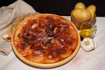 Image of Octopus Typical Spanish dish served with paprika, salt, potatoes and olive oil