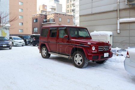 Téléchargez les photos : Hokkaido, Japan - December 20, 2022: A luxury Mercedes Benz G-Class parked on the street in the of Sapporo, Hokkaido - en image libre de droit