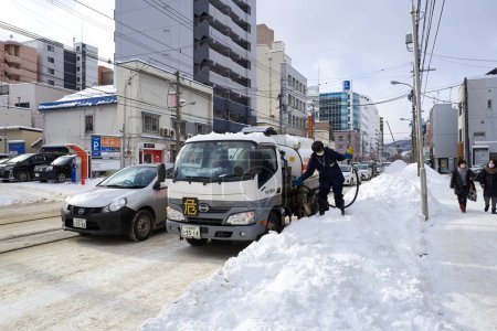 Téléchargez les photos : Hokkaido, Japan  - December 20, 2022 : Driver refuels his truck on the street in winter in Hokkaido - en image libre de droit