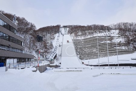 Foto de Hokkaido, Japan  - December 21, 2022 : The Okurayama Ski Jump Stadium in Sapporo City is a ski jumping venue and view point located in the Miyanomori area, Sapporo, Hokkaido, Japan. - Imagen libre de derechos