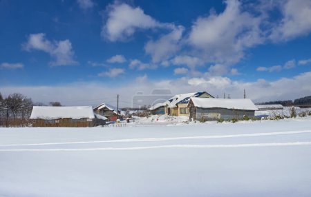 Photo for Empty snow-covered ground with beautiful winter small town - Royalty Free Image