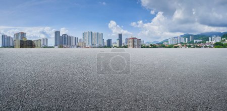 Empty asphalt floor with cityscape background