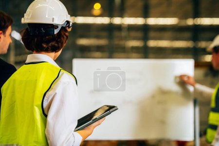 Happy warehouse engineer with safety vest using tablet for checking goods and supplies on shelves with goods background in warehouse store, Logistic and business export concept Poster 643953516