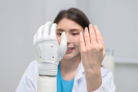 Photo for Professional technician testing robotic bionic arm at prosthetic manufacturing, Technician checking and controlling artificial prosthetic hand, Technology at prosthetic manufacturing - Royalty Free Image