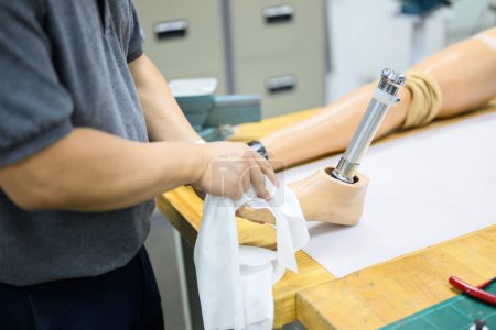 Photo for Male worker assembling parts of artificial leg in prosthetic production workshop, Development engineer with high tech technology at prosthetic manufacturing, New artificial limb production - Royalty Free Image