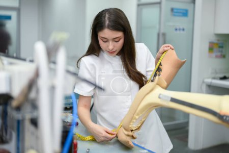Photo for Young female technician holding prosthetic leg checking and working in laboratory, Specialist with high tech technology at prosthetic manufacturing, New artificial limb production for disabled people - Royalty Free Image