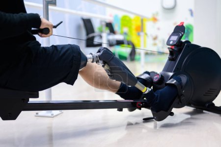 Photo for Disabled athlete patient with physical disability doing exercise routine indoor, People with high tech technology at prosthetic health care center, New artificial limb production for disabled people - Royalty Free Image
