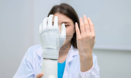 Photo for Professional technician testing robotic bionic arm at prosthetic manufacturing, Technician checking and controlling artificial prosthetic hand, Technology at prosthetic manufacturing - Royalty Free Image