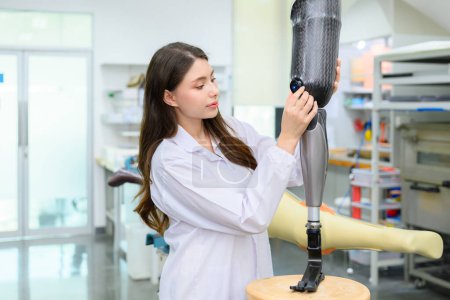 Photo for Female technician holding prosthetic limb checking and working in laboratory, Specialist with high tech technology at prosthetic manufacturing, New artificial limb production for disabled people - Royalty Free Image