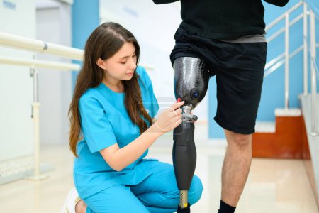 Photo for Physiotherapist adjusting prosthetic leg of patient in hospital, Disabled patient with treatment at health care center, New artificial limb production for disabled people - Royalty Free Image