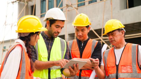 Photo for Civil engineers team with safety hard hat working together at construction site outdoor, Construction workers checking and controlling project on building site, Architecture engineering on new project - Royalty Free Image