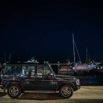 Sotogrante, Spain - January 27, 2024 - A car parked by the marina at night with boats and clear night sky in the background.