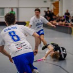 Valmiera, Latvia - February 17, 2024 - a moment during a floorball match where one player has fallen and others are in motion.