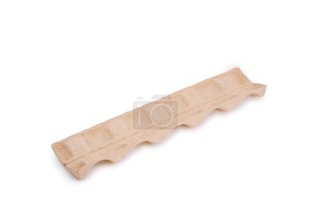 A wavy, beige cardboard packaging insert with contoured shapes for holding and protecting items, on a white background.
