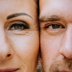 Valmiera, Latvia - August 10, 2023 - Close-up of a bride and groom's eyes, foreheads touching, showing intimacy and love.
