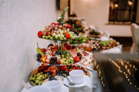 Valmiera, Latvia - August 19, 2023 - A tiered fruit platter beautifully arranged with a variety of fresh fruits, showcased at an event buffet.