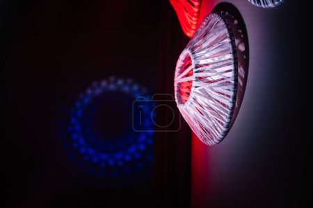 Valmiera, Latvia - May 5, 2024 - abstract, colorful lighting designs on a wall, including a blue circular pattern and a vibrant red, fan-shaped pattern.